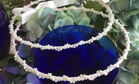 This wedding crown set is made by twogreekwomen.  It has a double wrap of delicate pearls and won't catch in the bride's hair (a big issue for the priest). 

Choose white or ivory, 3/4 inch or 1 inch connecting ribbon. 

Always in stock $75