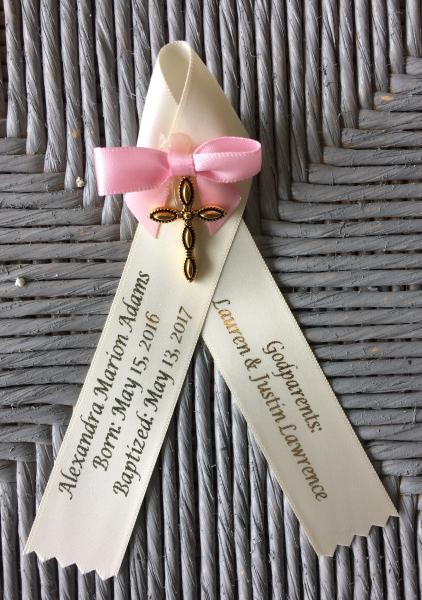 The latest in Baptism Witness Pins.  

Ivory ribbon, gold lettering, gold cross and pink ribbon.  Many colors and variations available. 