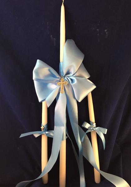 Simple and elegant.  White 24 inch candle adorned with double face satin ribbon and silver byzantine cross. 

$45 24 inch candle
$18 15 inch matching child's accessory candle.  

Purchase via our online store or contact us page. 