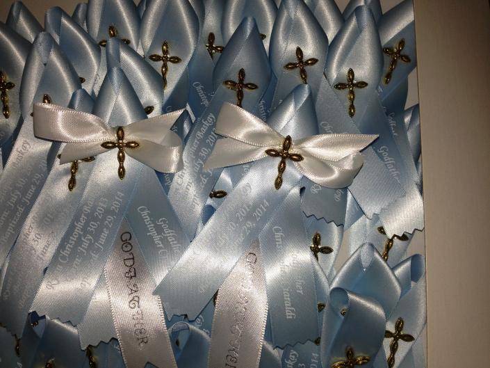 Baby blue and white matyrika with a brass finish cross for a special baby who needs an extra blessing.  Godparents are very special people and we added white bows to their witness pins. 