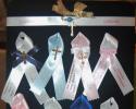 twogreekwomen will only supply the finest ribbons that won't fray and lettering that is clear and stands out.  We can customize pins, ribbons, or flowers.  Due to the quality of the ribbon, we can only order by 50, 100, 150.  If you need anything in between we will work with you on the pricing. 
