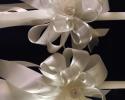 24 inch white candle set with light ivory ribbon, ceramic rose embellishment and a tough of ivory sheet ribbon to catch the church light. 

Church set of 2:  $95
